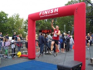 Leslie's brother Andrew leaping across the finish line