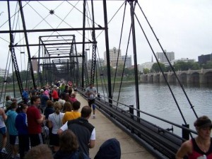 Runners crossing the bridge to the finish line